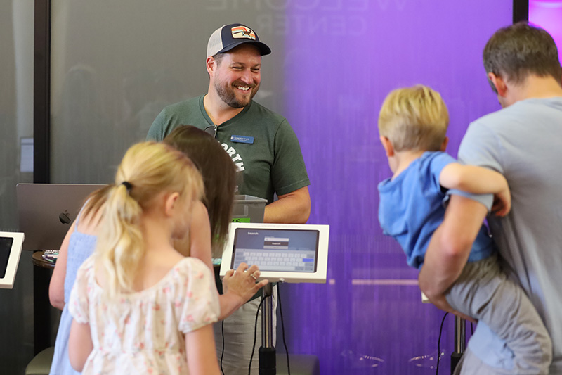 Leaders welcoming children at Vacation Bible School check in