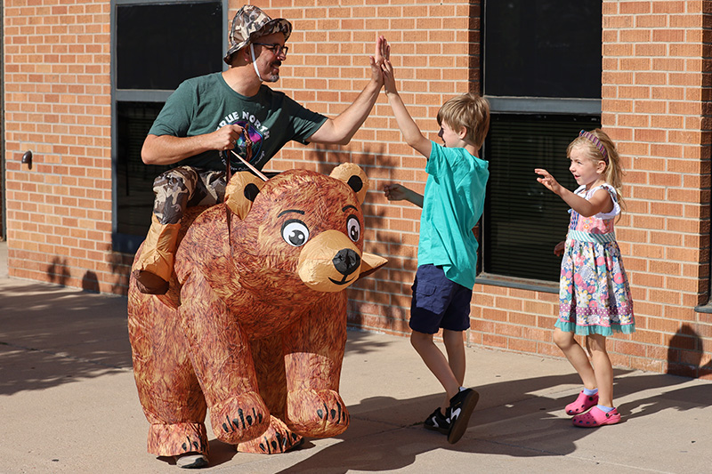Leaders and kids smiling together at Vacation Bible School