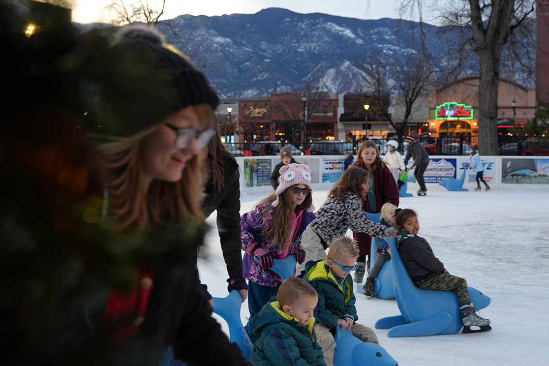 Families ice skating downtown